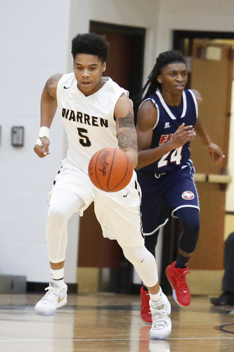 Harding's Kahmaree Bush (5) drives past Fitch's Bryce Hall (24) during their game at Harding High School, Friday, Jan. 22, 2016, in Warren, Ohio. Alex Slitz for The Vindicator