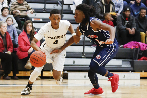 Harding's Gabe Simpson (4) drives past Fitch's Bryce Hall (24) during their game at Harding High School, Friday, Jan. 22, 2016, in Warren, Ohio. Alex Slitz for The Vindicator