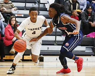 Harding's Gabe Simpson (4) drives past Fitch's Bryce Hall (24) during their game at Harding High School, Friday, Jan. 22, 2016, in Warren, Ohio. Alex Slitz for The Vindicator