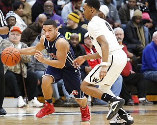 Fitch's Randy Smith (14) drives past Harding's Gabe Simpson (4) during their game at Harding High School, Friday, Jan. 22, 2016, in Warren, Ohio. Alex Slitz for The Vindicator