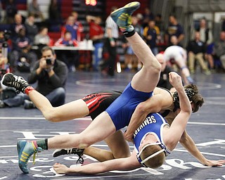 Poland's Dante Ginnetti, front, wrestles Girard's Dakota McCloskey during their 120 pound match during the 2016 Josh Hephner Memorial Tournament at Austintown-Fitch High School, Saturday, Jan. 23, 2016, in Youngstown, Ohio. Alex Slitz for The Vindicator