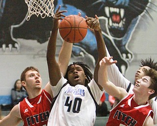 William D Lewis The Vindicator East"s M. wilder(40) pulls down a rebound between Fitch's Anthony Pangio(11) and Scotty Duffy (3) during 1-29-16 game at East.