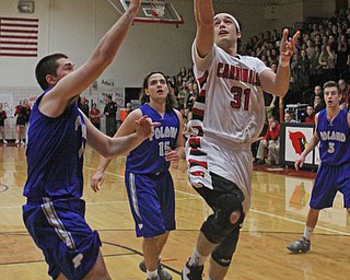 Canfield's Vince Ferrier (31) goes in for a layup while being defended by Poland's Jacob Burns (14) during Friday nights matchup at Canfield High School.  Dustin Livesay  |  The Vindicator  1/29/16  Canfield High School.