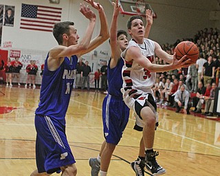 Canfield's Julian Vitto (32) goes up for a layup while being defended by Poland's Matt Baker (11) and Braeden O'Shaugnessy (20) during Friday nights matchup at Canfield High School.  Dustin Livesay  |  The Vindicator  1/29/16  Canfield High School.