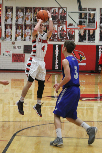 Canfield's Brandon McFall (4) takes a jump shot while being defended by Poland's Mike Gajdos (3) during Friday nights matchup at Canfield High School.  Dustin Livesay  |  The Vindicator  1/29/16  Canfield High School.