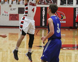 Canfield's Brandon McFall (4) takes a jump shot while being defended by Poland's Mike Gajdos (3) during Friday nights matchup at Canfield High School.  Dustin Livesay  |  The Vindicator  1/29/16  Canfield High School.