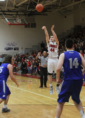Canfield's Mason Mangapora (44)  puts up a 3-pointer while being defended by Poland's Nick Bussieri (15)  during Friday nights matchup at Canfield High School.  Dustin Livesay  |  The Vindicator  1/29/16  Canfield High School.