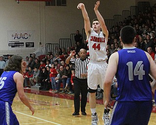Canfield's Mason Mangapora (44)  puts up a 3-pointer while being defended by Poland's Nick Bussieri (15)  during Friday nights matchup at Canfield High School.  Dustin Livesay  |  The Vindicator  1/29/16  Canfield High School.