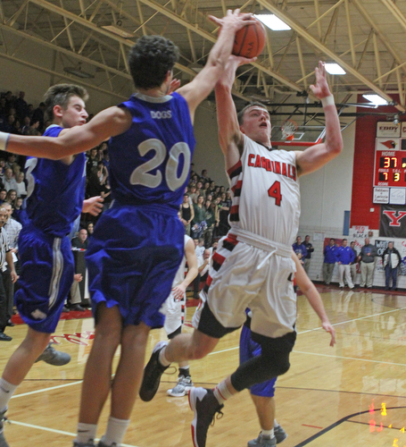 Canfield's Brandon McFall (4) has his shot blocked by Poland's Braeden O'Shaugnessy (20) during Friday nights matchup at Canfield High School.  Dustin Livesay  |  The Vindicator  1/29/16  Canfield High School.