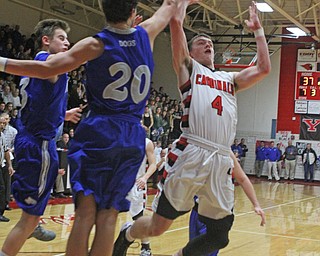 Canfield's Brandon McFall (4) has his shot blocked by Poland's Braeden O'Shaugnessy (20) during Friday nights matchup at Canfield High School.  Dustin Livesay  |  The Vindicator  1/29/16  Canfield High School.