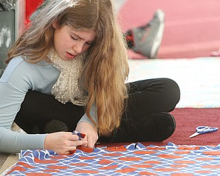      ROBERT K. YOSAY  | THE VINDICATOR..Tieing up the ends is  Samantha Smit 6th grader ..St. Charles School students huddled around tables in the cafeteria busying themselves with measuring, cutting and tying for a good cause..The fifth-through-eighth-graders were making blankets Tuesday morning for Making Kids Count, a nonprofit organization that helps children in Mahoning, Trumbull, Columbiana, Ashtabula and Portage counties..--30-...