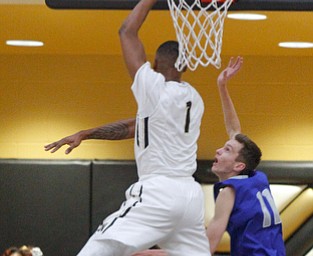      ROBERT K. YOSAY  | THE VINDICATOR..Goes for two as #1 Derek Culver  hooks  left and to the basket in front of Poland Defender #11matt baker tries to stop him during second quarter action..- --30-...