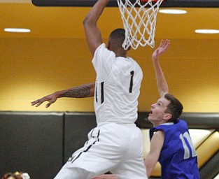      ROBERT K. YOSAY  | THE VINDICATOR..Goes for two as #1 Derek Culver  hooks  left and to the basket in front of Poland Defender #11matt baker tries to stop him during second quarter action..- --30-...