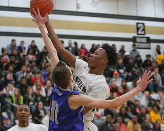      ROBERT K. YOSAY  | THE VINDICATOR..Hardings Shakem Johnson pushes by Polands Matt Baker for two - during first quarter action at Harding..- --30-...