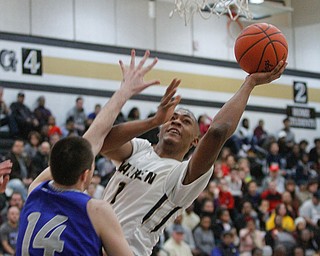      ROBERT K. YOSAY  | THE VINDICATOR..Goes for two as Derek Culver  moves left and to the basket in front of Poland Defender #14  Jacob Burns- during first quarter action at Harding..- --30-...