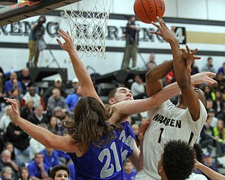      ROBERT K. YOSAY  | THE VINDICATOR..Blocked by  #14 Jacob Burns with a an arm in #! Hardings Derek Culver  moves  to the basket in front of Poland Defender #21Jake Buccieri - during second quarter action at Harding- ShakemJohnson in the foreground for Harding..- --30-...