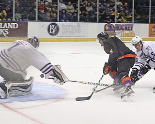 Youngstown Phantoms defensemen Vas Kolias (5) gets tripped up by Tri-City's John Marino (5) while taking a shot on goalie Jake Kielly (1) during the first period of Friday nigths matchup at the Covelli Center in downtown Youngstown.  Dustin Livesay  |  The Vindicator  2/5/16  Covelli Center.