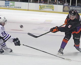 Youngstown Phantoms defensemen Ryan Shea (6) takes a shot on goal while being defended by Dan Labosky (24) of the Tri-City Storm during the first period of Friday nigths matchup at the Covelli Center in downtown Youngstown.  Dustin Livesay  |  The Vindicator  2/5/16  Covelli Center.