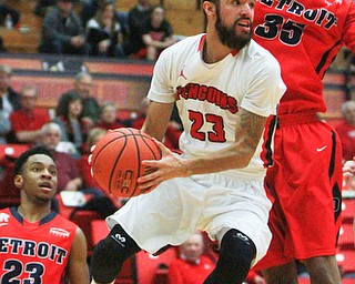 William d lewis The Vindicator YSU's Francisco santaigo(23) goes airbornbetween Detroits Josh McFolley(23) and Paris Bass(35) during 2-6-15 action.