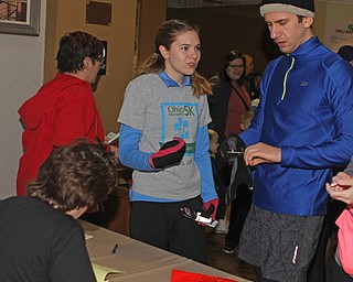 Siblings , D'Ella (left) and Auggie (right) Heschmeyer of Youngstown , register for the first running of the Paczki Dash 5K inside the lobby of the Poland Library on Saturday morning.   Dustin Livesay  |  The Vindicator  2/6/16  Poland, Ohio.