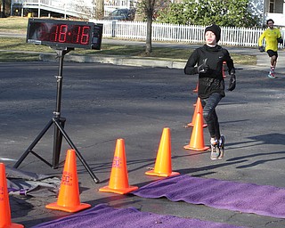 Vincent Mauri (15) of Howland finishes in first place overall on Saturday morning during the Paczki Dash 5K outside of the Poland Library. Jonathan Bolha of Austintown finished in second place just moments after Mauri.  Dustin Livesay  |  The Vindicator  2/6/16  Poland, Ohio.