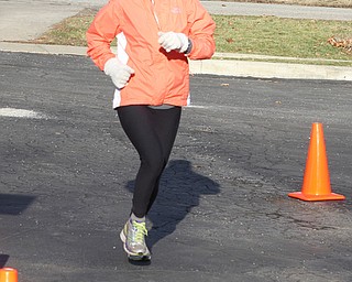 Kaite Heney of Boardman finishes in first place among females during the Paczki Dash 5K on Saturday morning outside of the Poland Library.   Dustin Livesay  |  The Vindicator  2/6/16  Poland, Ohio.