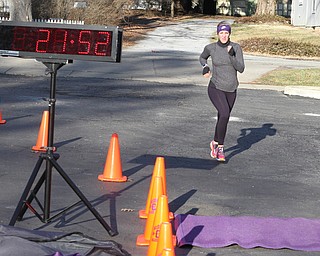Courtney Kunkel of McDonald finishes the Paczki Dash 5K in second place among females on Saturday morning outside of the Poland Library.   Dustin Livesay  |  The Vindicator  2/6/16  Poland, Ohio.