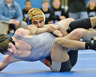 Jeff Lange | The Vindicator  THURS, FEB 11, 2016 - Frank Viera of Howland (rear) wraps up with Poland Seminary's Brandon Olsen during their 138 pound bout Thursday night at Poland Seminary High School.
