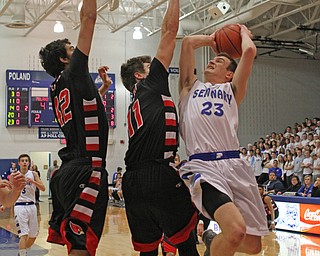 Poland's Jared Burkert (23) attempts a jump shot while being defended by Canfield's Sam Digiacomo (42) and Jared Clark (11) during the first quarter of Friday nights matchup at Poland High School.  Dustin Livesay  |  The Vindicator  2/12/16  Poland.