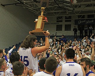 Poland'sNick Buccieri (15) holds up the "battle of 224" trophy after defeating Canfield at Poland High School on Friday night.  Dustin Livesay  |  The Vindicator  2/12/16  Poland.