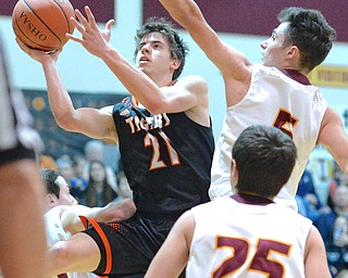 Jeff Lange | The Vindicator  FRI, FEB 12, 2016 - Springfield senior Graham Mincher (21) looks to the basket as he makes a layup to break Springfield High School's all-time scoring record during first half action at South Range High School on Friday. (Also pictured) South Range's Mark Vennetti (25) and Preston Stitt.