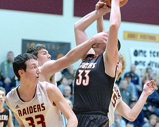 Jeff Lange | The Vindicator  FRI, FEB 12, 2016 - Tigers' Grant Nezbeth (right) is slapped in the face by South Range's Mitch Dolak (back left) as Mitch Dolak (33) looks on from the left during first half action of their basketball game at South Range High School on Friday.