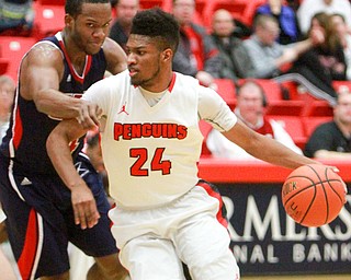 William D. Lewis The Vindicator YSU's Cameron Morse(24) drives around UIC's Lance Whitaker(4) during2-16-16 action at YSU.