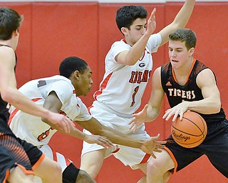 Jeff Lange | The Vindicator  TUE, FEB 16, 2016 - Springfield's Frankie Centofanti (right) maintains possession as he is pressured by Girard's Collin Harden (left) and Anthony Granziano (center) during the first half of their basketball game at Girard High School on Tuesday.