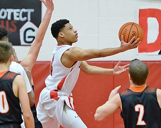 Jeff Lange | The Vindicator  TUE, FEB 16, 2016 - Durrel Richardson of Girard (center) looks to the basket for a layup against Springfield's Jake Ford (30) and Frankie Centofanti (2) in the third quarter of their basketball game at Girard High School on Tuesday.