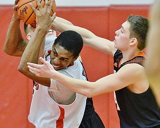 Jeff Lange | The Vindicator  TUE, FEB 16, 2016 - Girard's Collin Harden (left) battles for the ball against Springfield's Jordan Capouellez in the fourth quarter of their game at Girard High School on Tuesday.