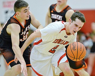 Jeff Lange | The Vindicator  TUE, FEB 16, 2016 - Girard's Mark Standohar (right) drives to the basket past Tigers' Jake Ford in the fourth quarter of their game at Girard High School on Tuesday.