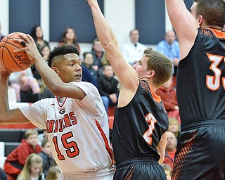 Jeff Lange | The Vindicator  TUE, FEB 16, 2016 - Indians' Darren Tiggett (15) looks for an open teammate past Springfield's Frankie Centofanti (2) and Grant Nezbeth (33) in the first quarter of their game at Girard High School on Tuesday.