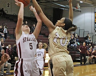Warren Harding's Shymara Dykes (10) blocks a shot attempt by Boardman's Jenna Vivo (5) during the first quarter of Thursday nights matchup at Boardman High School.  Dustin Livesay  |  The Vindicator  2/18/16  Boardman.