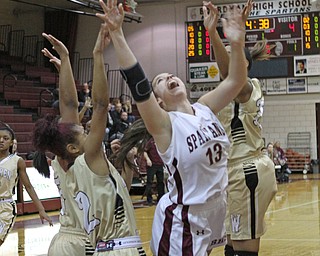 Boardman's Krista Johnson (13) puts up a layup after being triple teamed by the Warren Harding defense during the first quarter of Thursday nights matchup at Boardman High School.  Dustin Livesay  |  The Vindicator  2/18/16  Boardman.