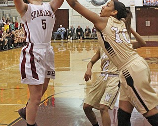 Boardman's Jenna Vivo (5) gets fouled while taking a jump shot by Warren Harding's Shymara Dykes (10) during the first quarter of Thursday nights matchup at Boardman High School.  Dustin Livesay  |  The Vindicator  2/18/16  Boardman.