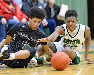 Jeff Lange | The Vindicator THU, FEB 18, 2016 - Harding's Tiryn Frank (left) looks to make a play on a lose ball against Ursuline's Tristan Ballard in the second quarter of their game at Ursuline High School on Thursday.