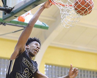 Jeff Lange | The Vindicator  THU, FEB 18, 2016 - Harding's Shakem Johnson (21) looks to the net as he slams the ball through the hoop in the fourth quarter of the Raiders' basketball game at Ursuline High School on Thursday. Harding defeated Ursuline 83-72.