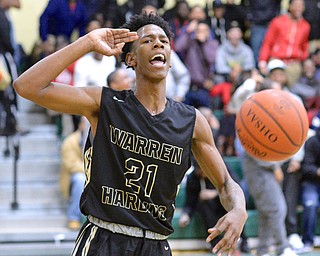 Jeff Lange | The Vindicator  THU, FEB 18, 2016 - Warren Harding's Shakem Johnson salutes after slamming the ball through the net late in the fourth quarter of the Raiders' game at Ursuline High School.