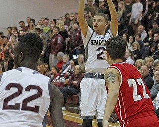 Boardman's Gannon Murray (2) attempts a 3-pointer while being defended by Austintown Fitch's Derek Gunter during the first quarter of Friday nights matchup at Boardman High School.  Dustin Livesay  |  The Vindicator  2/19/16  Boardman High School.