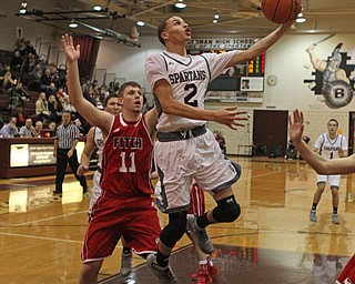 Boardman's Gannon Murray (2) goes in for a layup while being defended by Austintown Fitch's Anthony Pangio (11) during the first quarter of Friday nights matchup at Boardman High School.  Dustin Livesay  |  The Vindicator  2/19/16  Boardman High School.