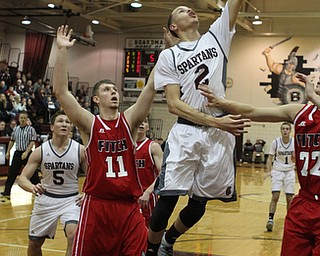 Boardman's Gannon Murray (2) goes in for a layup while being defended by Austintown Fitch's Anthony Pangio (11) during the first quarter of Friday nights matchup at Boardman High School.  Dustin Livesay  |  The Vindicator  2/19/16  Boardman High School.