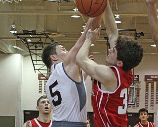 Austintown Fitch's Brian Beany (33) goes in for a layup while being defended by Boardman's Alex Duda (5) during the second quarter of Friday nights matchup at Boardman High School.  Dustin Livesay  |  The Vindicator  2/19/16  Boardman High School.