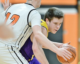 Jeff Lange | The Vindicator  FRI, FEB 19 2016 - Champion's Michael Turner drives past Mineral ridge's Albert Alli during second quarter action of their game at Mineral Ridge High School on Friday.