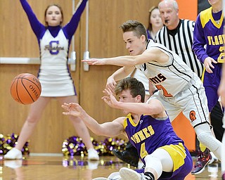 Jeff Lange | The Vindicator  FRI, FEB 19 2016 - Champion's R.J. Smith (4) passes the ball under Mineral Ridge's Riko Rodriguez in the second quarter of their game at Mineral Ridge High School on Friday.